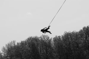Girl on a rope Silhouette of a girl jumping with a rope from the bridge